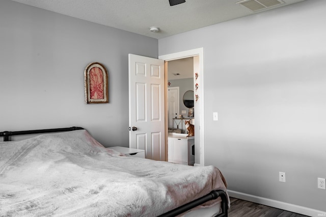 bedroom featuring baseboards, a ceiling fan, wood finished floors, and visible vents
