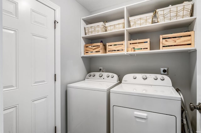 clothes washing area with laundry area and washer and clothes dryer