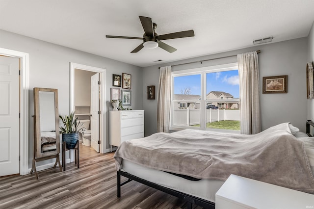 bedroom featuring visible vents, connected bathroom, ceiling fan, and wood finished floors
