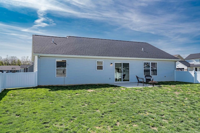 rear view of property with a fenced backyard, a patio, and a yard