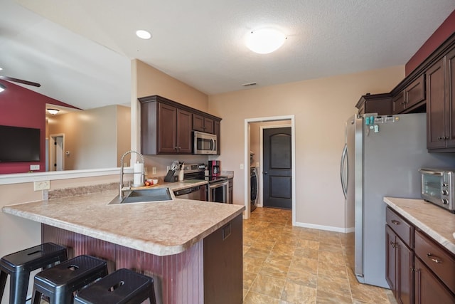 202 Jeremy Dr, Milford, IN 46542 - kitchen featuring appliances with stainless steel finishes, a sink, light countertops, washer / clothes dryer, and a toaster