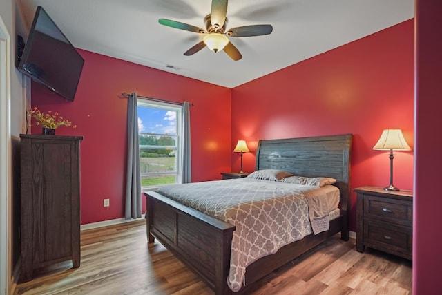 202 Jeremy Dr, Milford, IN 46542 - bedroom with ceiling fan, baseboards, visible vents, and wood finished floors