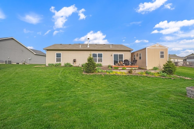 202 Jeremy Dr, Milford, IN 46542 - rear view of house with a lawn and central AC unit