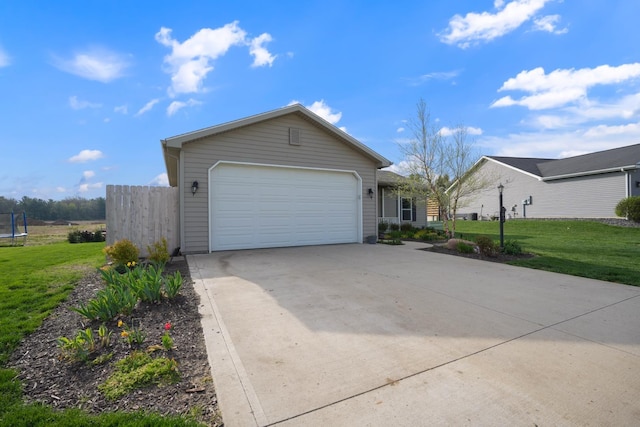 202 Jeremy Dr, Milford, IN 46542 - view of front facade with fence, a trampoline, a front lawn, a garage, and concrete driveway