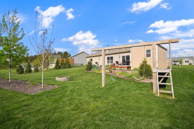 202 Jeremy Dr, Milford, IN 46542 - back of property with an outdoor fire pit and a yard