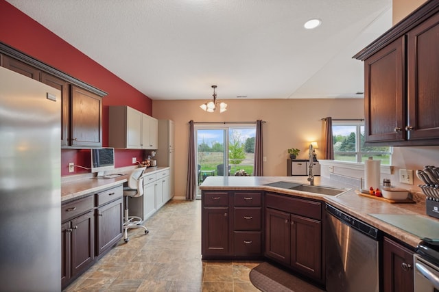202 Jeremy Dr, Milford, IN 46542 - kitchen with built in desk, a sink, a chandelier, stainless steel appliances, and a peninsula