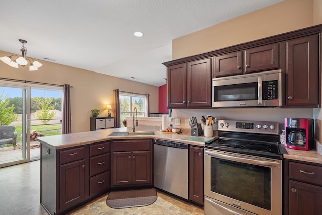 202 Jeremy Dr, Milford, IN 46542 - kitchen featuring an inviting chandelier, a sink, plenty of natural light, stainless steel appliances, and a peninsula