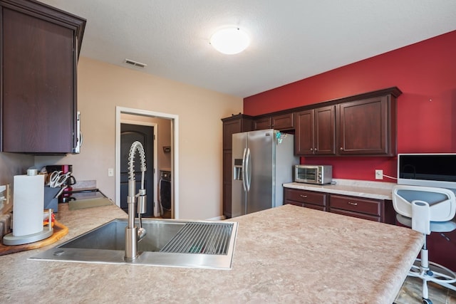 202 Jeremy Dr, Milford, IN 46542 - kitchen with dark brown cabinets, appliances with stainless steel finishes, light countertops, a toaster, and visible vents
