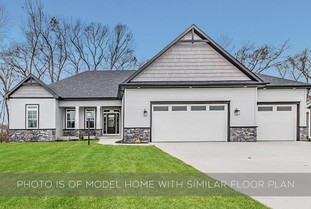 craftsman house featuring an attached garage, a front yard, stone siding, and concrete driveway