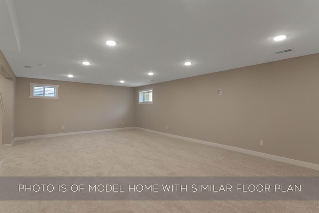 below grade area with baseboards, carpet flooring, recessed lighting, and visible vents