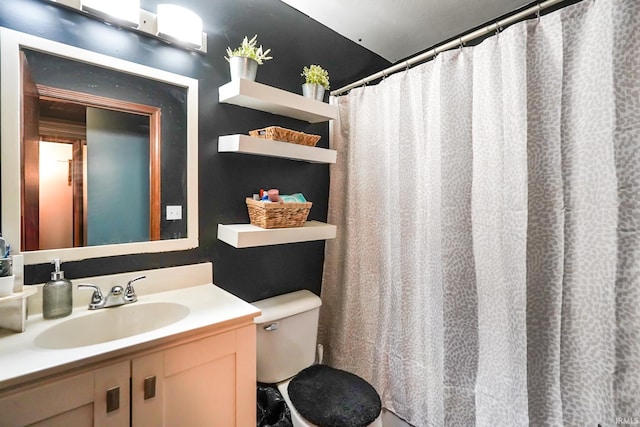 full bath featuring vanity and toilet