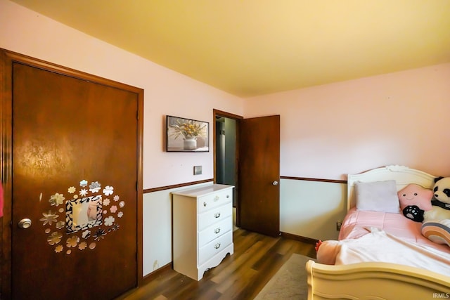 bedroom with baseboards and dark wood-style floors