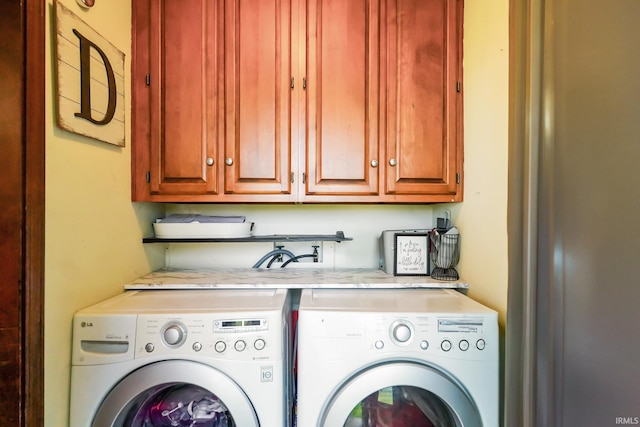 laundry room with cabinet space and separate washer and dryer