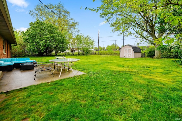 view of yard featuring a storage unit, a patio, an outbuilding, and outdoor lounge area