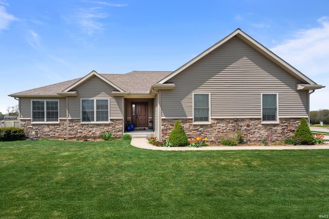 view of front of house with a shingled roof, stone siding, and a front yard