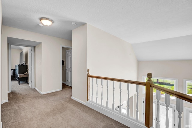 7911 N Thames Dr, Bloomington, IN 47408 - hall featuring baseboards, an upstairs landing, and light carpet