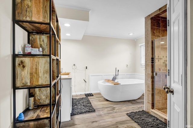 7911 N Thames Dr, Bloomington, IN 47408 - full bathroom with crown molding, a freestanding tub, a stall shower, and wood finished floors