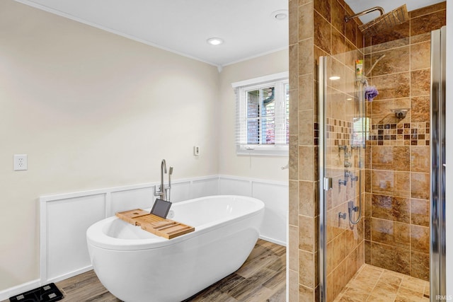 7911 N Thames Dr, Bloomington, IN 47408 - bathroom featuring a shower stall, wood finished floors, a wainscoted wall, ornamental molding, and a soaking tub