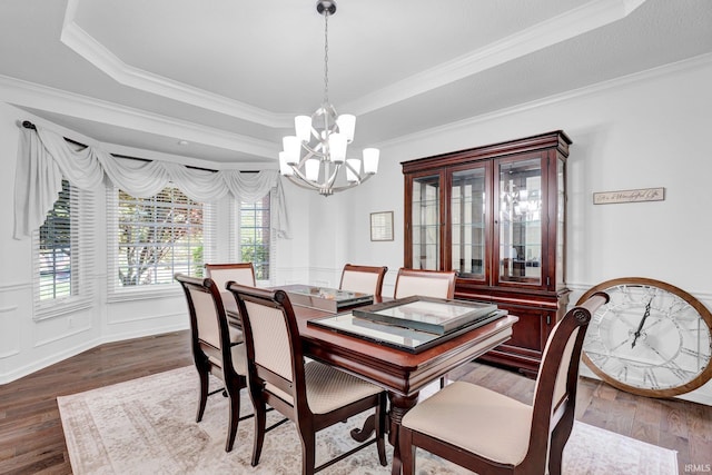 7911 N Thames Dr, Bloomington, IN 47408 - dining room with a notable chandelier, ornamental molding, wood finished floors, and a raised ceiling