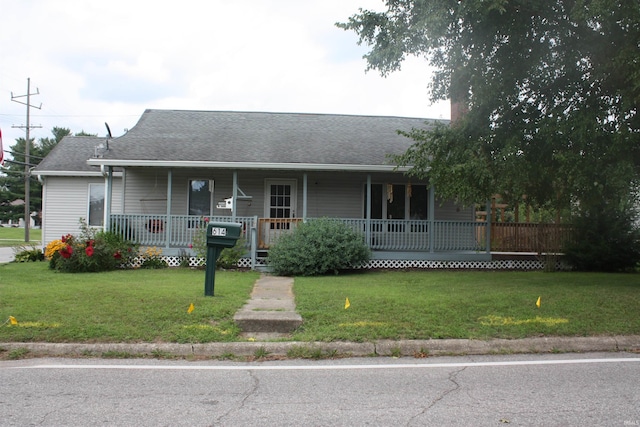view of front of property with covered porch and a front lawn