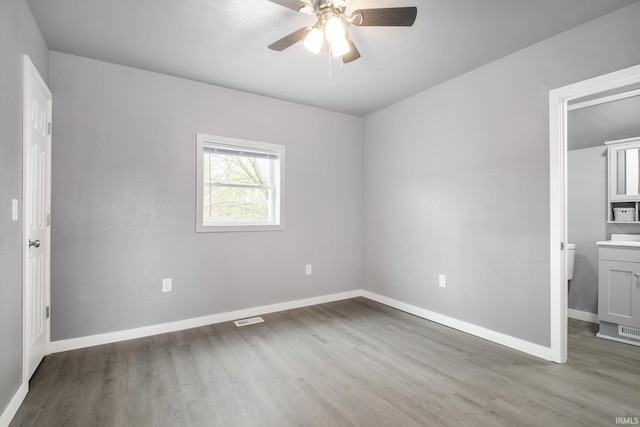 unfurnished bedroom with visible vents, a ceiling fan, baseboards, and wood finished floors
