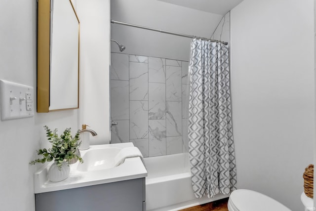 bathroom with vanity, shower / bathtub combination with curtain, and toilet