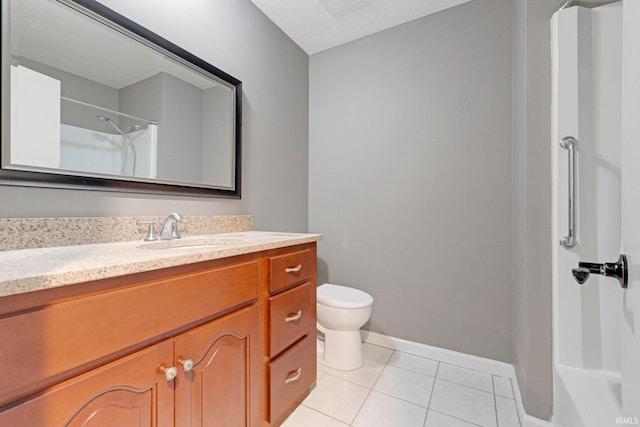 bathroom with vanity, a shower, toilet, baseboards, and tile patterned floors