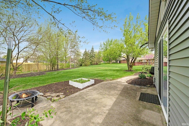 view of yard featuring fence private yard, an outdoor fire pit, and a patio area