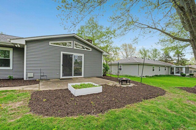 back of property featuring a lawn and a fire pit