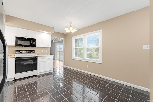 kitchen featuring an inviting chandelier, black microwave, dark tile patterned floors, white cabinetry, and electric stove