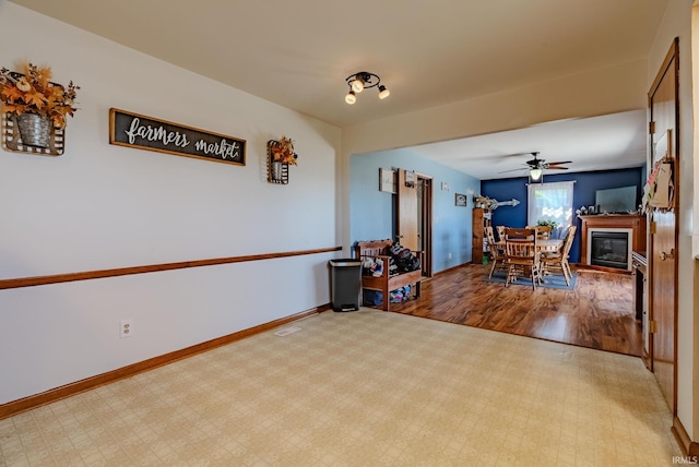 3678 W 200 N, Wabash, IN 46992 - interior space with a glass covered fireplace, baseboards, ceiling fan, and wood finished floors