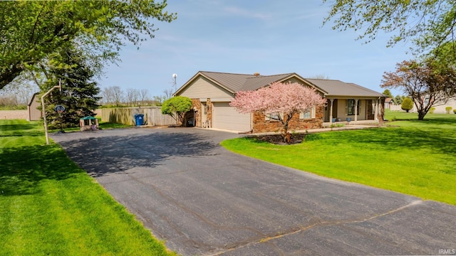 3678 W 200 N, Wabash, IN 46992 - ranch-style home with driveway, metal roof, a front yard, a garage, and stone siding