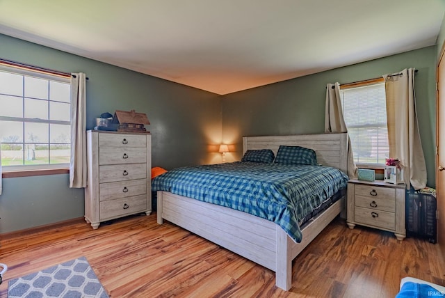 3678 W 200 N, Wabash, IN 46992 - bedroom featuring baseboards, multiple windows, and wood finished floors