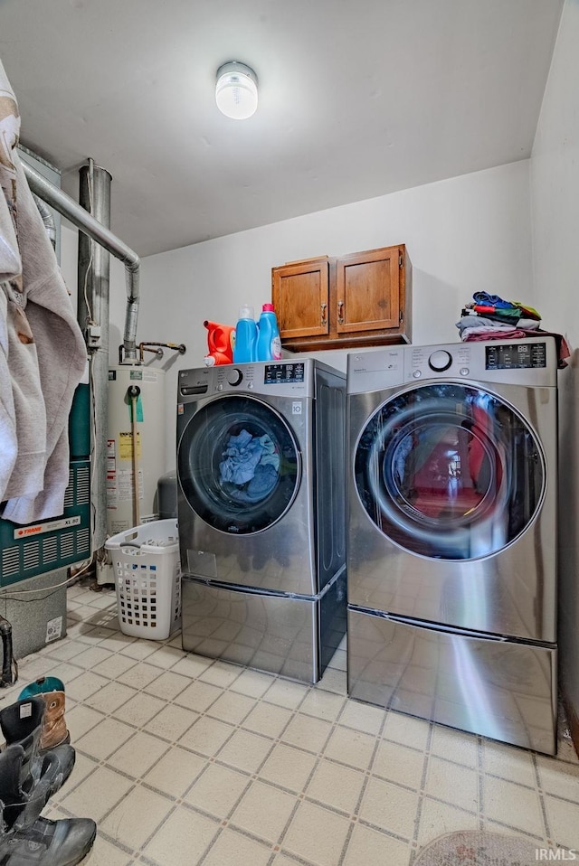 3678 W 200 N, Wabash, IN 46992 - clothes washing area featuring washer and clothes dryer, cabinet space, and gas water heater