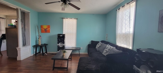 living room with baseboards, a ceiling fan, and wood finished floors