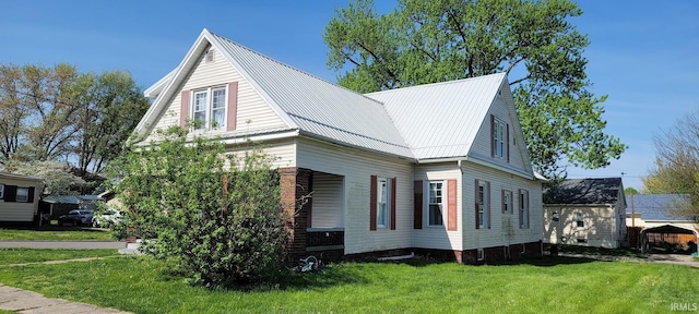 view of property exterior featuring a yard and metal roof