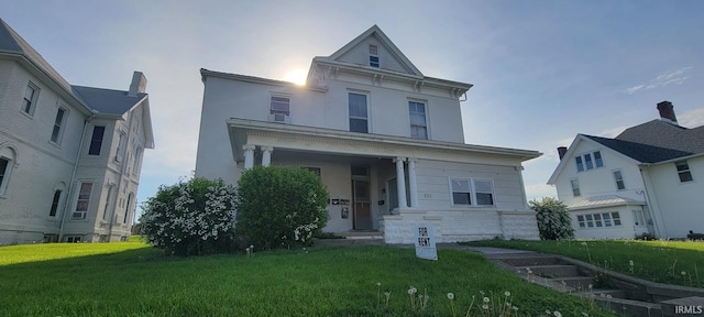 view of front of house featuring a front lawn, stucco siding, and stone siding