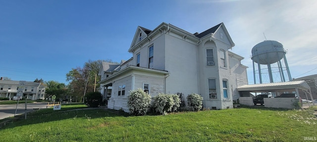 view of property exterior with stucco siding and a yard