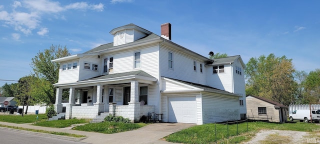 view of front facade featuring an attached garage, covered porch, a chimney, and concrete driveway
