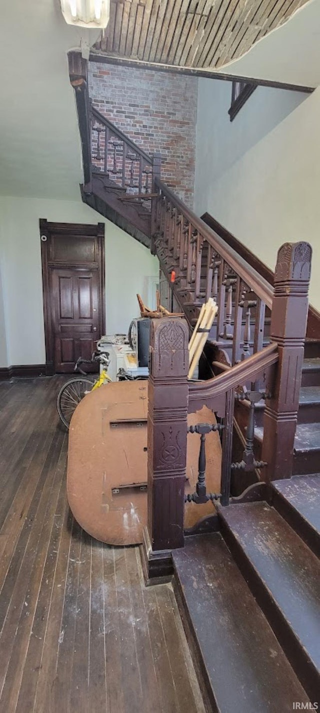 stairs featuring baseboards and hardwood / wood-style flooring
