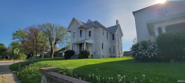 view of home's exterior with a lawn and stucco siding