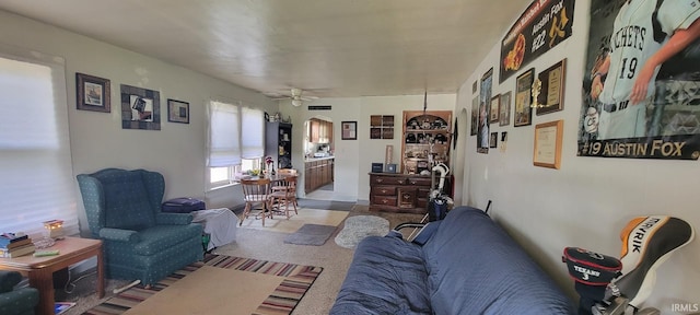 living room featuring arched walkways and ceiling fan