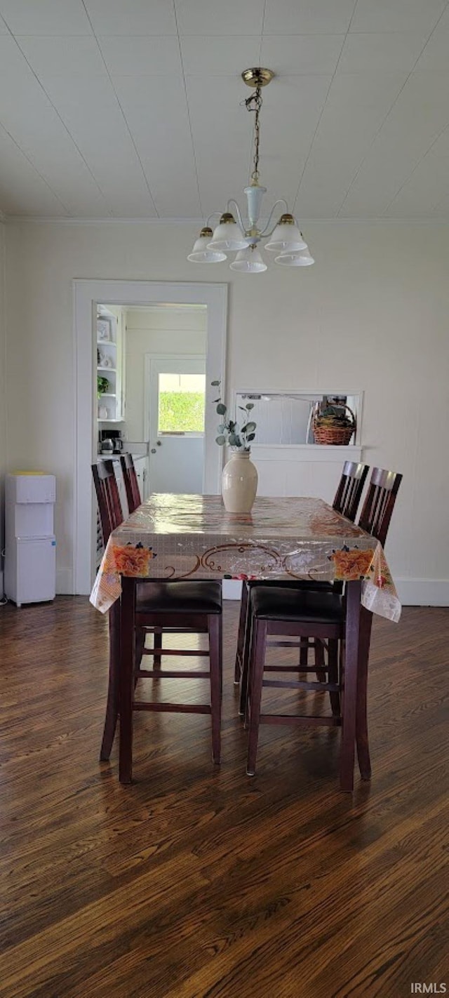 dining room featuring baseboards, a notable chandelier, and dark wood-type flooring