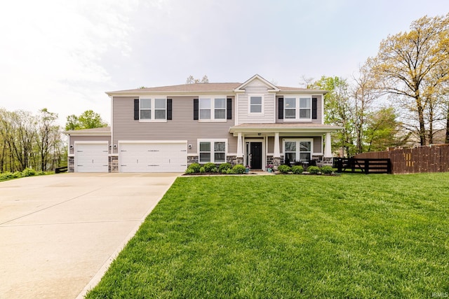 view of front of home with a porch, driveway, fence, a front lawn, and stone siding