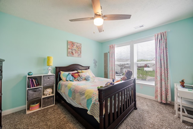 bedroom with visible vents, baseboards, a textured ceiling, a ceiling fan, and carpet