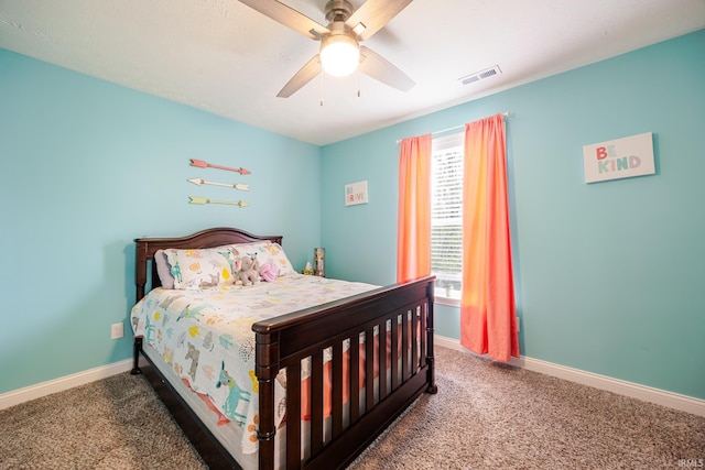 carpeted bedroom with visible vents, baseboards, and multiple windows