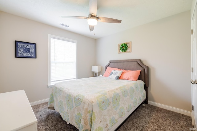 bedroom with carpet floors, baseboards, visible vents, and multiple windows