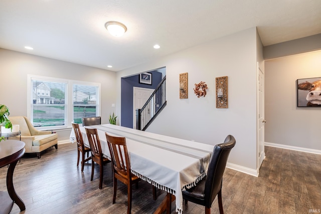 dining room with dark wood-style flooring, baseboards, recessed lighting, and stairway