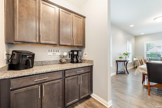 bar featuring baseboards, recessed lighting, and wood finished floors