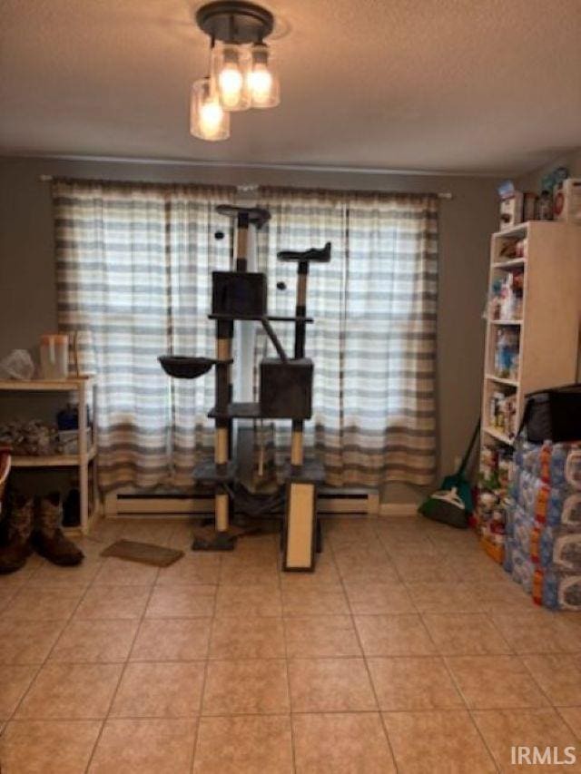 dining room featuring baseboard heating and tile patterned flooring